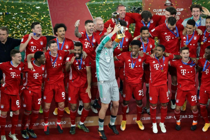 Bayern Munich captain Manuel Neuer (C) lifts the Club World Cup trophy