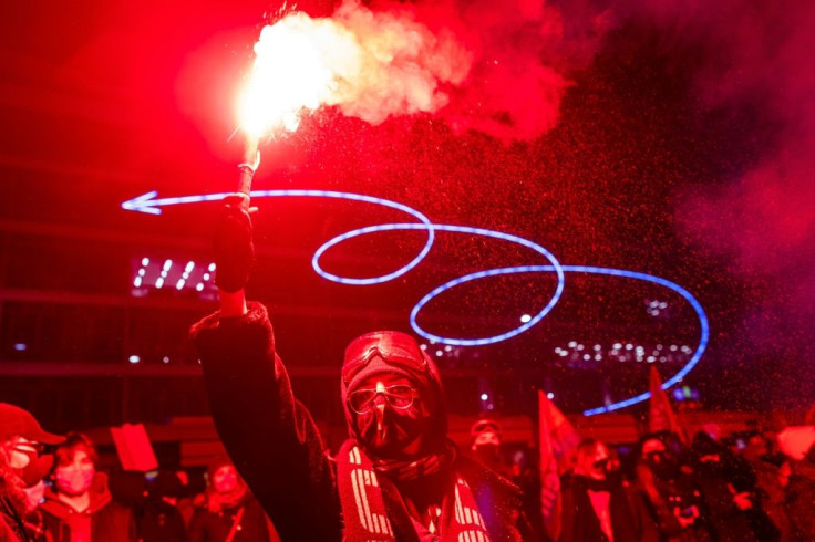 A demonstrator holds-up a flare as they take part in pro-choice demonstration in the center of Warsaw on January 29, 2021