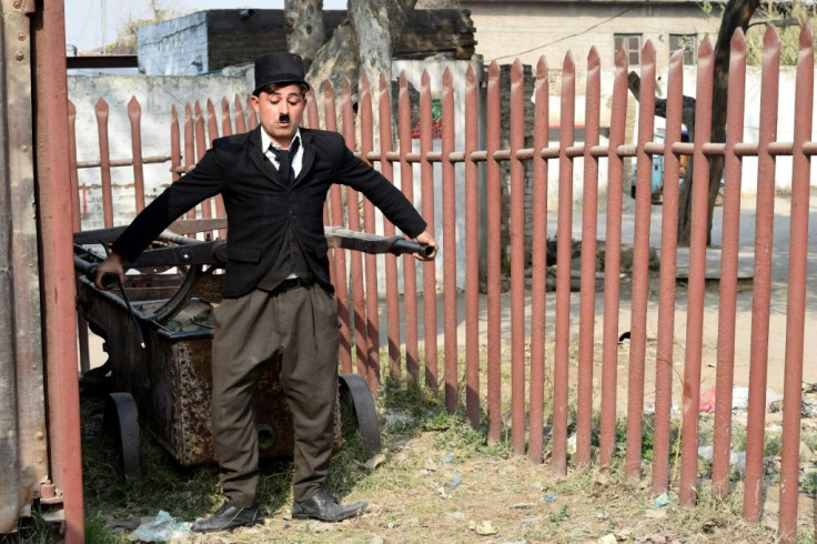 Khan leaps into passing rickshaws, annoys local shopkeepers, and occasionally swats onlookers with his cane as he shuffles bow-legged across the city of Peshawar