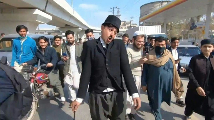 Wearing a bowler hat and familiar toothbrush moustache, Pakistan's Usman Khan darts through traffic swinging a cane, teasing motorists and shopkeepers for laughs and a few rupees with a Charlie Chaplin impersonation that has become a viral sensation.