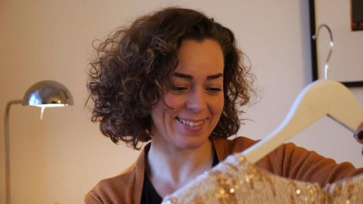 Mari Solberg looks at her wedding dress in her Oslo apartment, hoping to be able to wear it in summer 2021