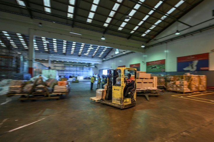 Storage: Workers move goods inside Kenya Airways' cargo facility at the Jomo Kenyatta International Airport in Nairobi