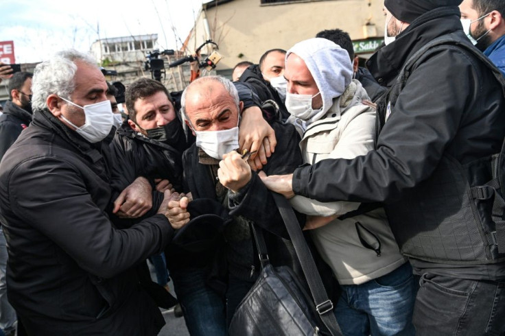Turkish plain-clothed police officers hold protesters during a demonstration in support of Bogazici University students on February 11, 2011