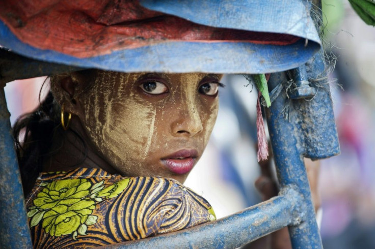 In this file photo taken on May 21, 2015, an ethnic Rohingya Muslim woman looks back as she rides a 'tuk tuk' near a camp set up outside the city of Sittwe in Rakhine state