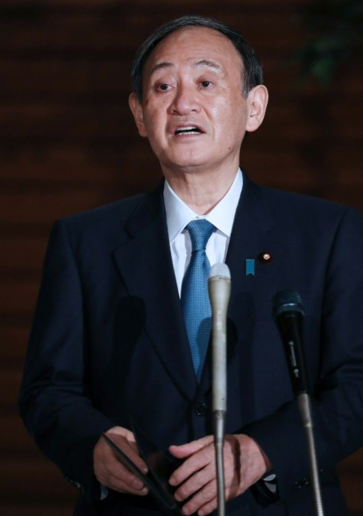 Japan's Prime Minister Yoshihide Suga speaks to the media following the earthquake, which he said produced no major casualties