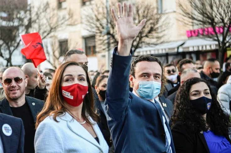 Albin Kurti, waving, is banned from running, but he could be chosen as PM if his party wins