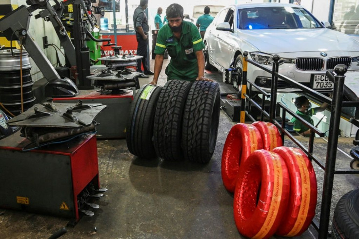 Workers check tyres at a repair shop in Colombo. Foreign-made tyres are also in short supply in Sri Lanka