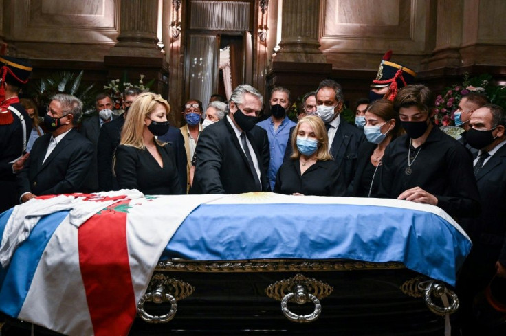President Alberto Fernandez (C) and his wife Fabiola Yanez (L) stand by Carlos Menem's coffin with the late former president's daughter Zulema Menem (2R), her mother Zulema Yoma (2R) and her son Luca Bertoldi Menem (R) in the Argentine Senate