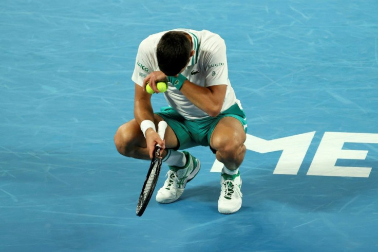 Novak Djokovic grimaces after a point against Milos Raonic on Sunday night