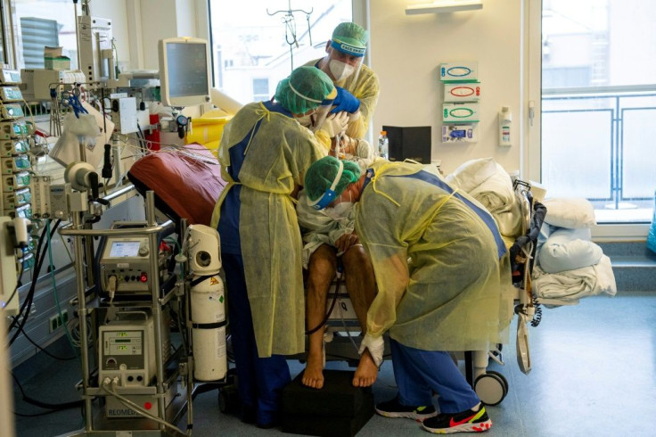 Medical staff examine a patient on a Covid-19 intensive care unit at the Klinikum Rechts der Isar hospital in Munich, German