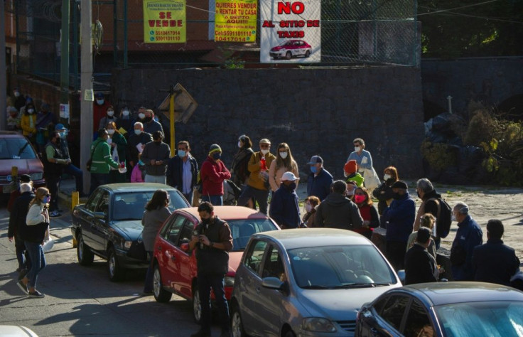People queue to receive their first dose of the AstraZeneca vaccine against Covid-19 in Mexico City on February 15, 2021