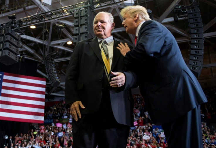 (FILES) In this file photo taken on November 05, 2018, Then-president Donald Trump speaks to radio host Rush Limbaugh at a Make America Great Again rally in 2018