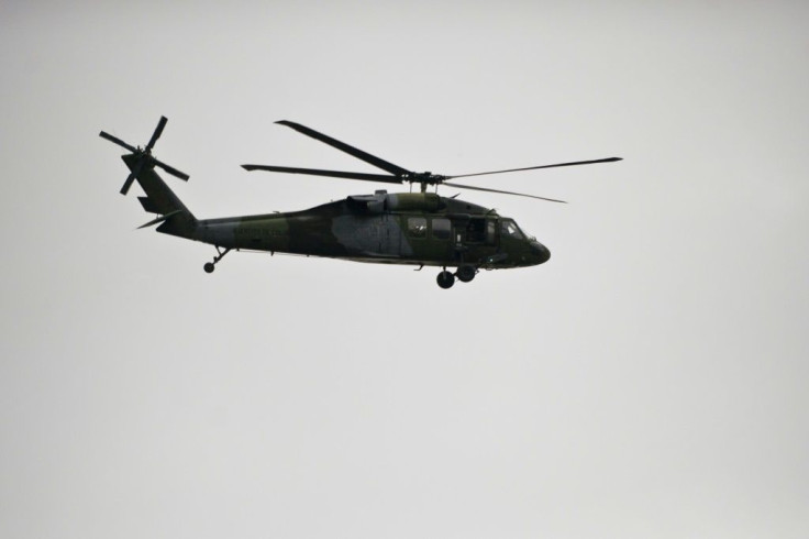 A Colombian Army Black Hawk helicopter flies over an area where a FARC guerrillas attack took place in Cali, Colombia, in April 2015
