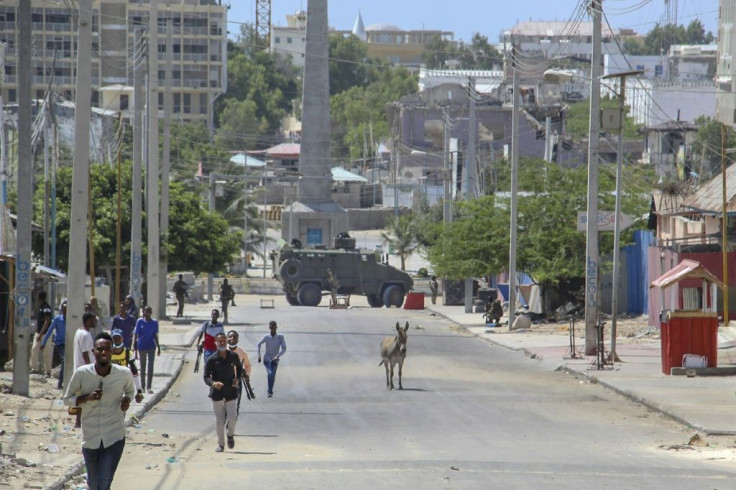 Men flee the site of the violent clashes in the Somali capital