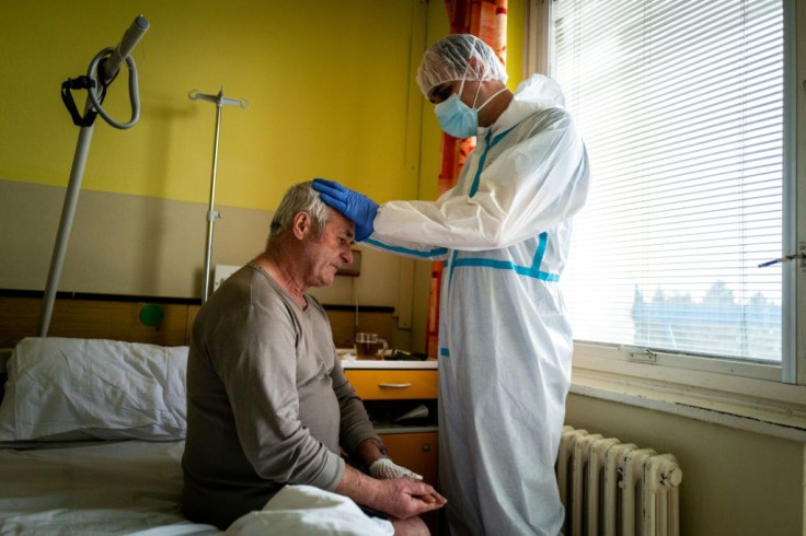 A priest prays with a Covid-19 patient at a hospital in the eastern Slovakia city of Presov