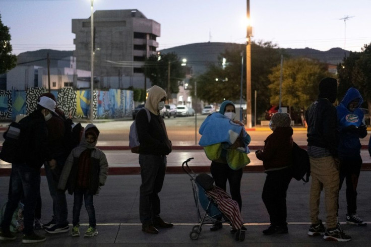 Asylum-seekers queue at the El Chaparral border crossing in Tijuana, Mexico
