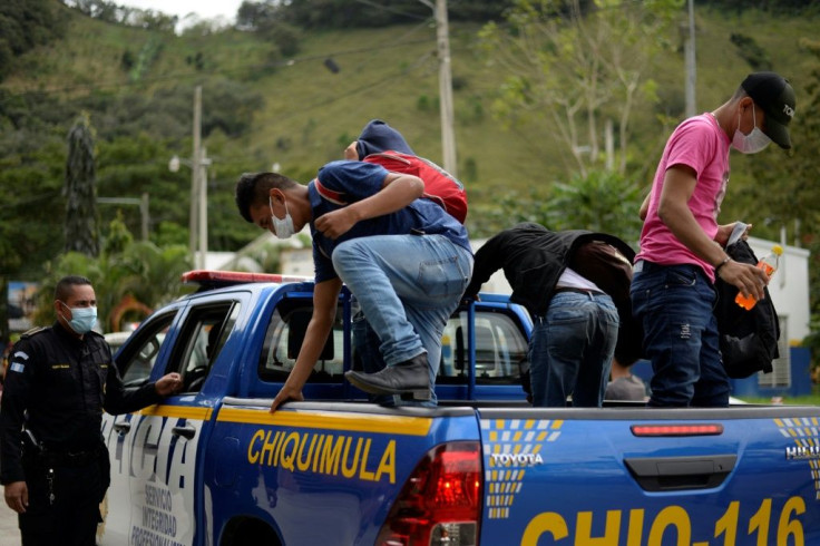 Honduran migrants get off a police truck in El Florido, Guatemala as they voluntarily return to their home country in January 2021