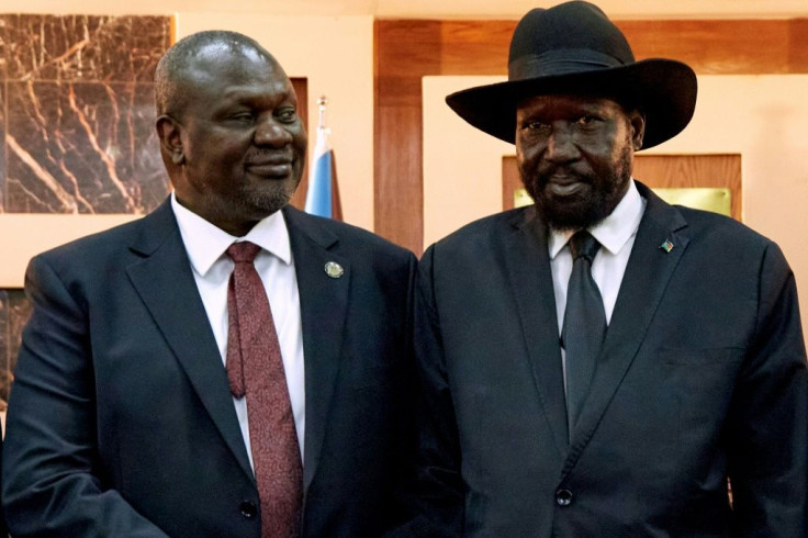 South Sudanese President Salva Kiir (R) shakes hands with First Vice President Riek Machar in 2020