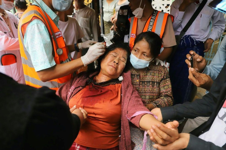 A protester receives treatment after being injured during the clashes