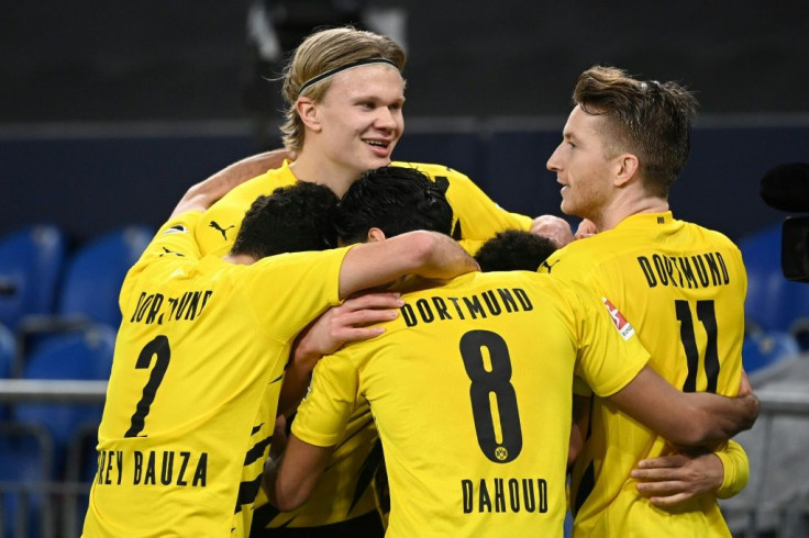 Erling Braut Haaland (L) celebrates scoring with a superb volley at Schalke on Saturday