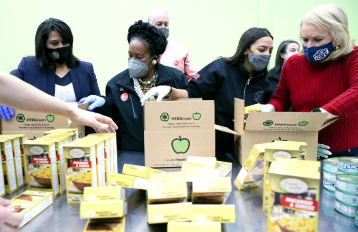 (L-R) Texas congresswoman Penny Morales Shaw, US congresswomen Sheila Jackson Lee, Alexandria Ocasio-Cortez and Sylvia Garcia help distribute food at the Houston Food Bank on February 20, 2021