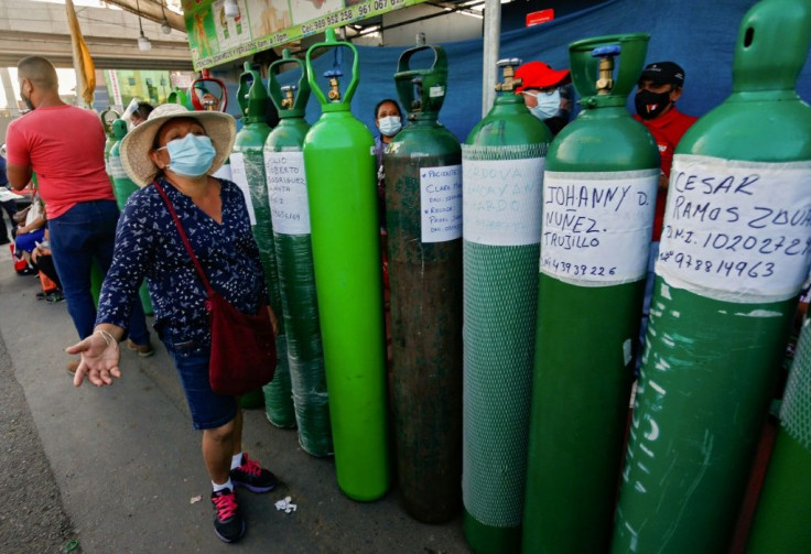 People wait in long lines to get medical oxygen in San Juan de Lurigancho, near Lima, Peru