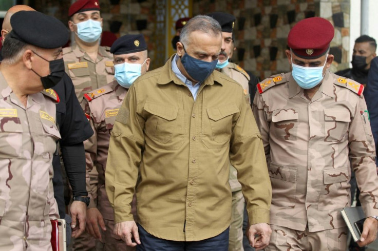Iraqi Prime Minister Mustafa al-Kadhemi (C) visits army headquarters in Tarmiyah on Saturday following clashes with Islamic State group fighters