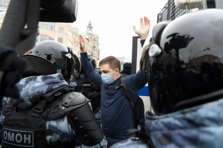 Riot police detain a man during a rally in support of jailed opposition leader Alexei Navalny in Moscow