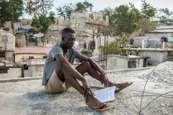 Kervens Casseus, 20, studies on the roof of his uncle's house in Port-au-Prince on February 18, 2021, one of many young Haitians deeply affected by political crisis, economic inequality and street crime