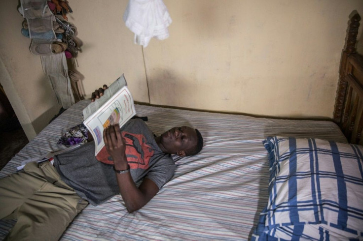 Kervens Casseus, 20, studies at his aunt's house in Port-au-Prince, fearful of even going out onto the street