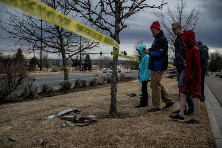 Residents inspect damage from debris fallen from a United Airlines airplane's engine in Broomfield, outside Denver, Colorado, on February 20, 2021