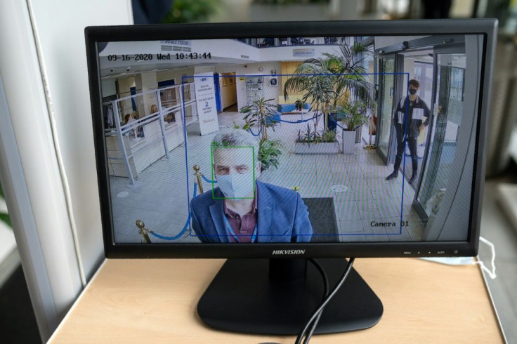 A member of staff at the University of Bolton in northern England has his body temperature checked by an automatic walk-through scanner to help to mitigate the spread of the novel coronavirus