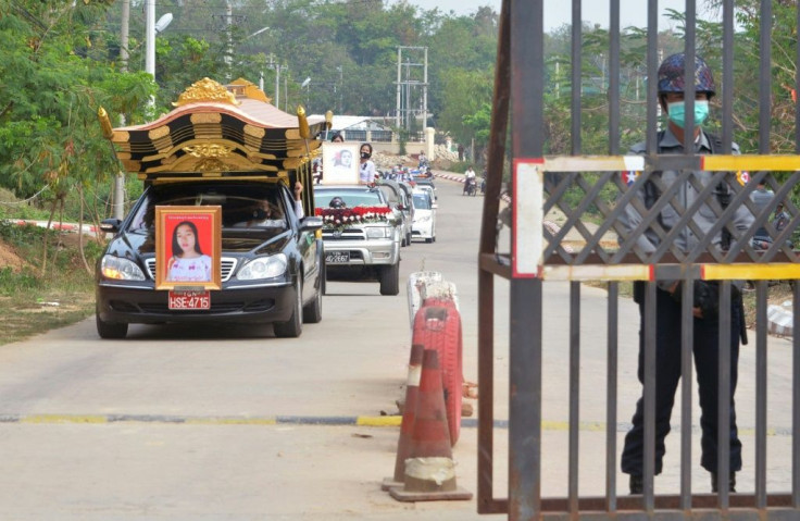 Mya Thwate Thwate Khaing's body was carried to the funeral hall alongside vehicles decorated with floral wreaths and photographs of the deceased