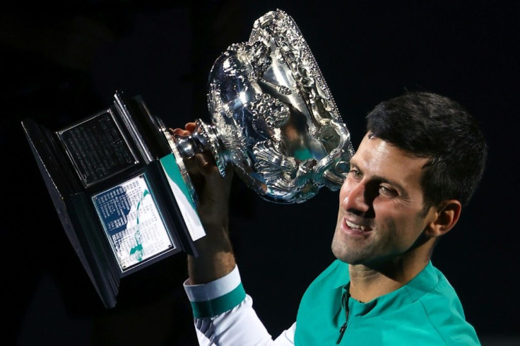 Novak Djokovic lifts the Norman Brookes Challenge Cup for the ninth time