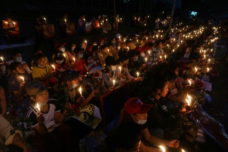 Protesters hold a candlelight vigil outside the US embassy in Yangon during a demonstration against the coup