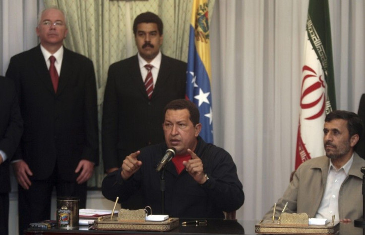 Venezuela&#039;s President Chavez speaks next to Iran&#039;s President Ahmadinejad during an official meeting in Tehran