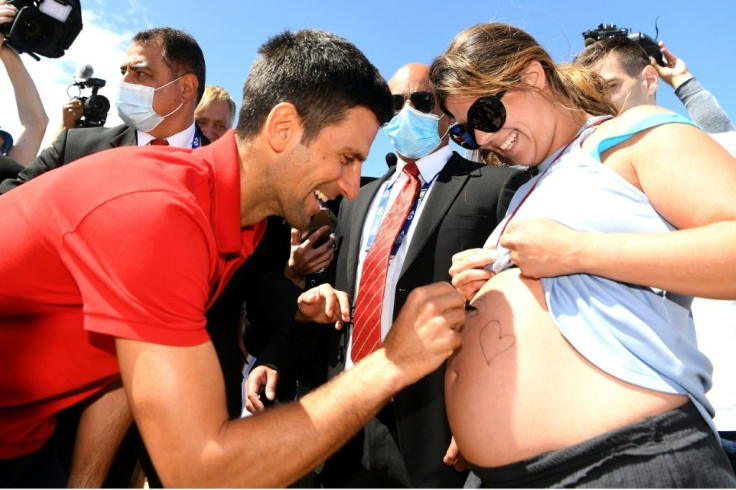 Djokovic signed a pregnant woman's stomach at Melbourne's Brighton Beach