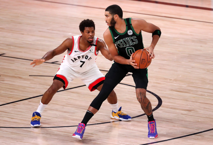 Kyle Lowry #7 of the Toronto Raptors defends Jayson Tatum #0 of the Boston Celtics