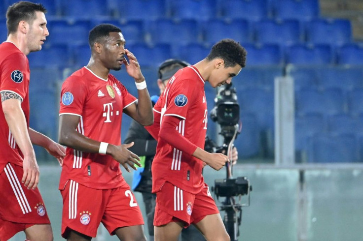 Bayern Munich's England Under-21 midfielder Jamal Musiala (R) celebrates scoring his first Champions League goal