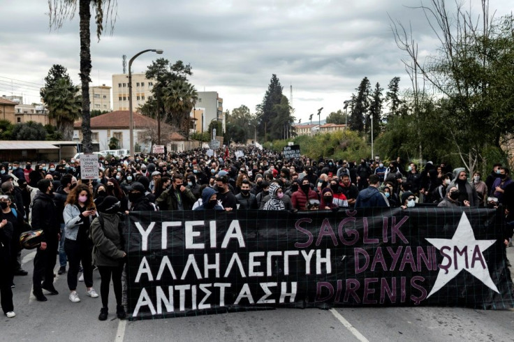 Protesters march with a banner reading "Health, Solidarity, Resistance" during another demonstration in Nicosia on Saturday