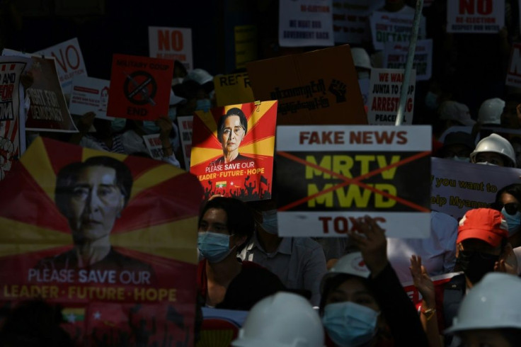 A sign featuring Aung San Suu Kyi is held up by protesters as they take part in a demonstration against the military coup in front of the Indonesian embassy in Yangon on Wednesday