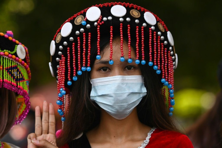 A protester makes the three-finger salute while taking part in a demonstration against the military coup in Yangon