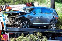 A tow truck holds the vehicle Tiger Woods drove in a crash that injured him