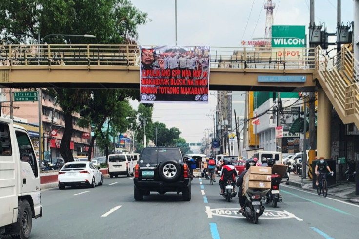 An anti-communist banner displayed on an overhead footbridge in Manila