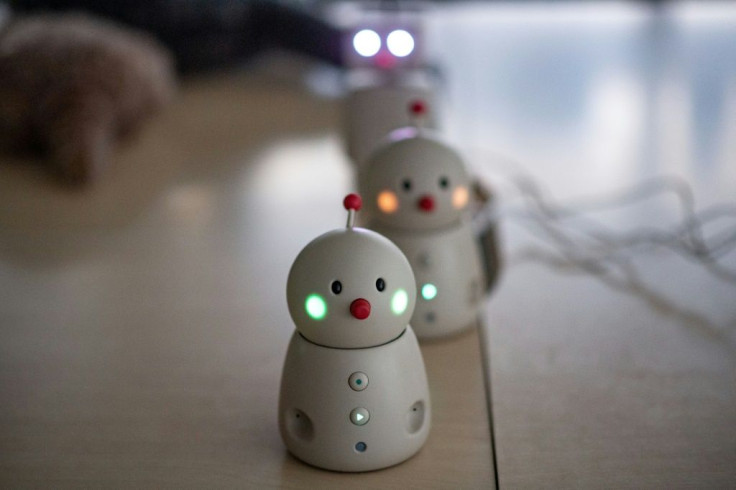 The Bocco emo robots (front and middle) allow families to leave and send voice messages through their phones