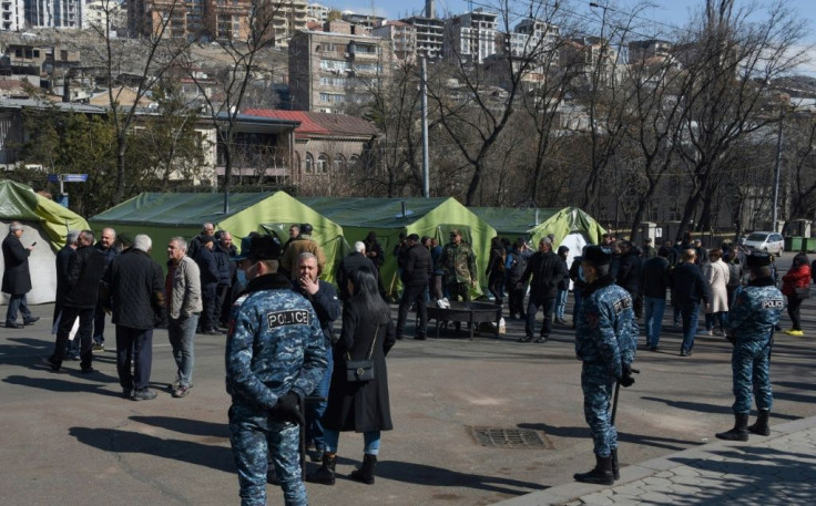 Opposition supporters gather by tents set near the National Assembly building in Yerevan