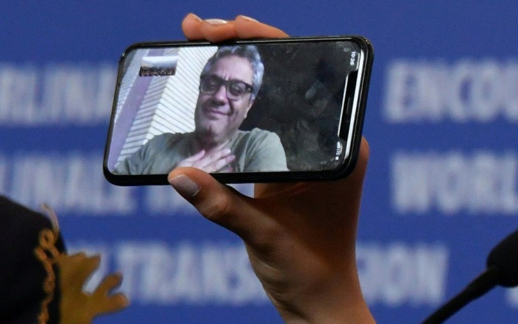 A phone displays Iranian director Mohammad Rasoulof, who was awarded the 2020 "Golden Bear for Best Film"
