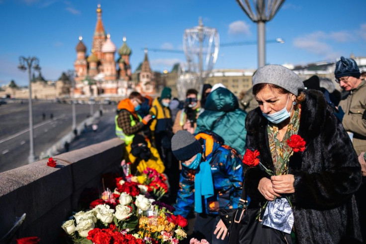 People lay flowers in central Moscow on February 27, 2021 at the site where late opposition leader Boris Nemtsov was fatally shot
