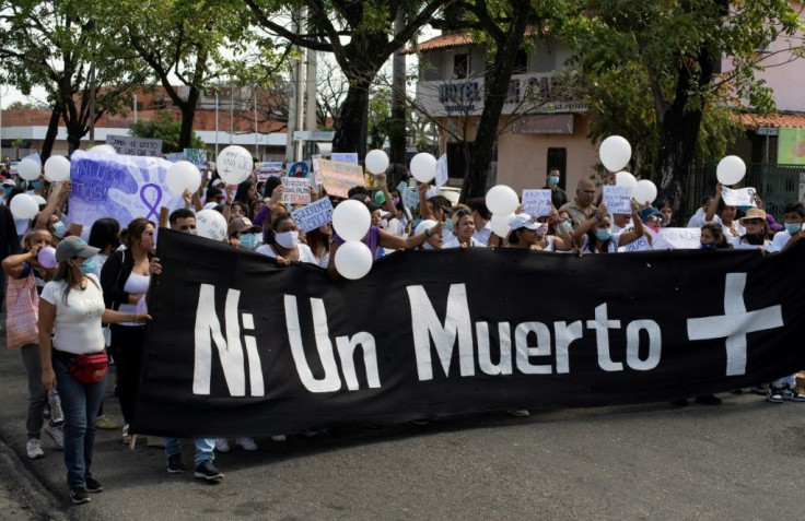 People protest in Acarigua, Venezuela, on February 27, 2021, demanding justice just days after three young women were murdered in Portuguesa state