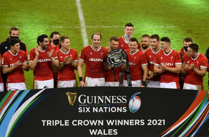 Triple joy - Wales captain Alun Wyn Jones (C) and fly-half Dan Biggar (centre right) hold the Triple Crown trophy after a 40-24 win over England